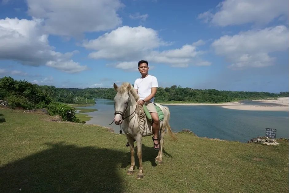 A first-time rider on a calm white Sandalwood pony